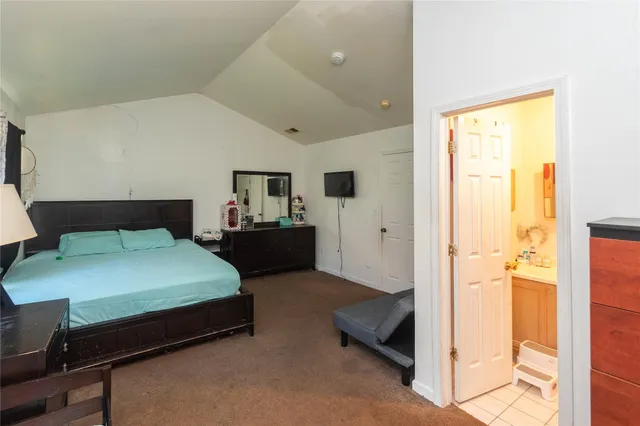 a bedroom with a bed and a table