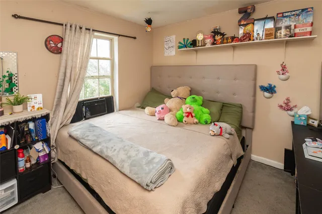 a bedroom with bed and a window