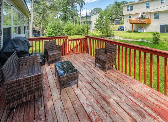 a view of a wooden deck with furniture