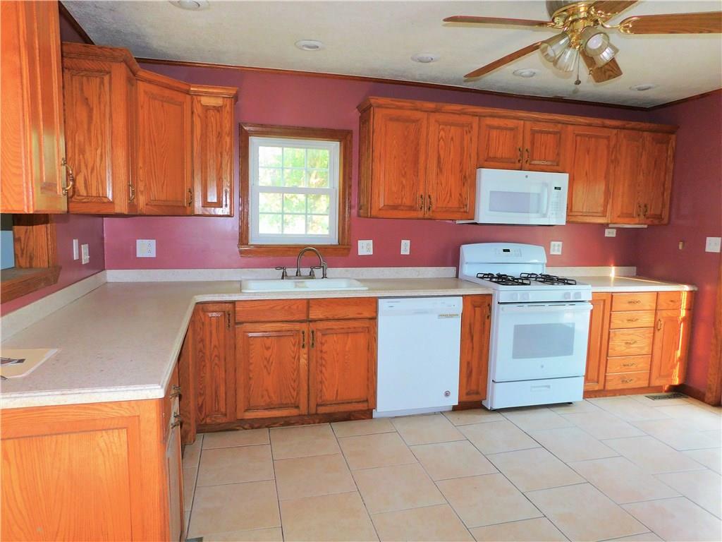 428 Sarver Road Sarver, PA 16055 - Photo 8 of 25 a kitchen with a stove sink and cabinets
