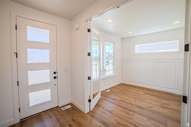 45 North Scarlet Maple Road, Unit 4317 Vineyard, UT 84059 - Photo 6 of 35 Entryway featuring a modern front door with frosted glass panels, wood-finish flooring, and recessed lighting
