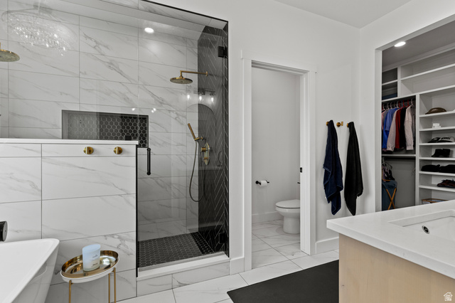 3111 South 1250 West Logan, UT 84321 - Photo 17 of 51 Spacious bathroom featuring a glass-enclosed shower with dual showerheads, a built-in shower niche, and black hexagon tile flooring