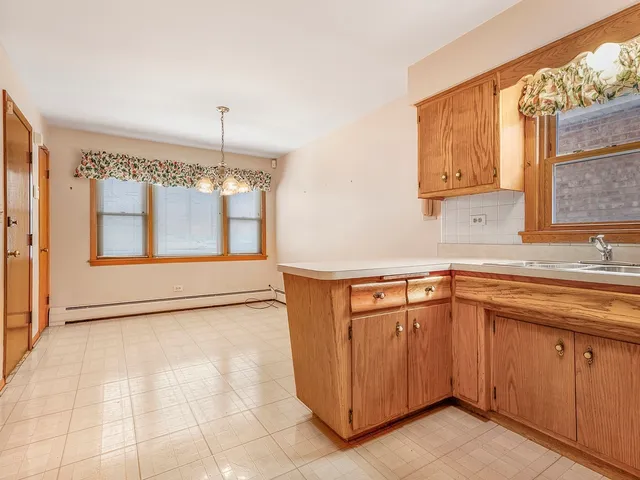 a kitchen with a sink window and cabinets