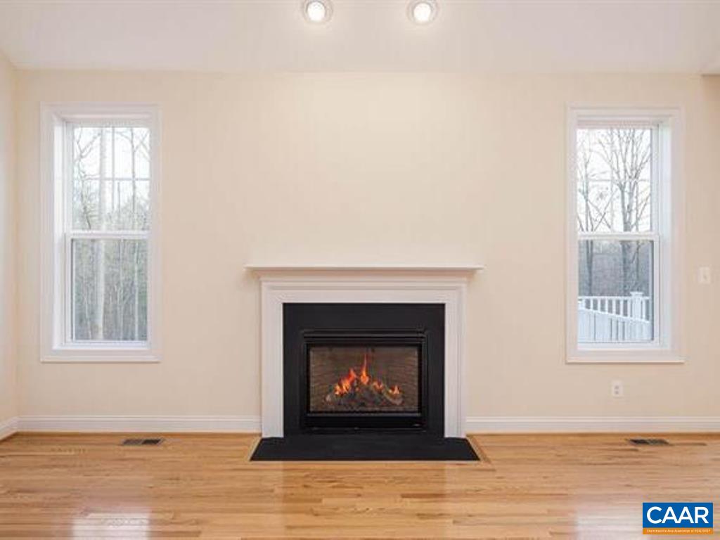 6 Ridgeview Drive Ruckersville, VA 22968 - Photo 14 of 32 a living room with a fireplace and a window
