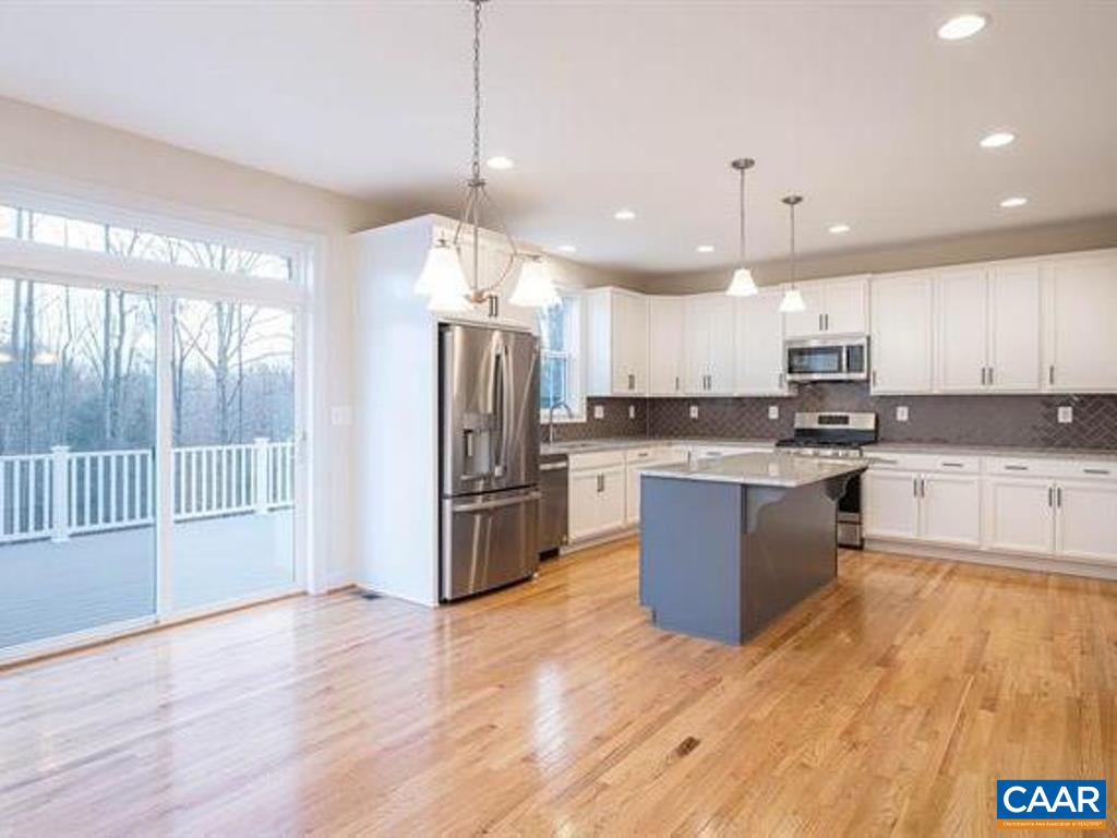 6 Ridgeview Drive Ruckersville, VA 22968 - Photo 17 of 32 a kitchen with stainless steel appliances kitchen island granite countertop a refrigerator a sink a stove and a wooden floors