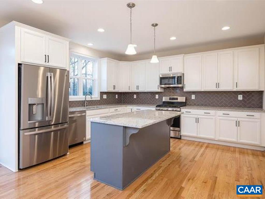 6 Ridgeview Drive Ruckersville, VA 22968 - Photo 18 of 32 a kitchen with stainless steel appliances granite countertop a refrigerator a stove a sink and white cabinets