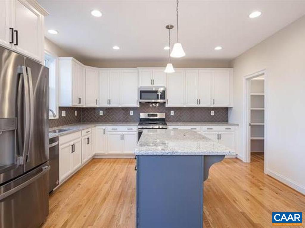 6 Ridgeview Drive Ruckersville, VA 22968 - Photo 19 of 32 a large kitchen with stainless steel appliances granite countertop a stove a sink a refrigerator and white cabinets with wooden floor