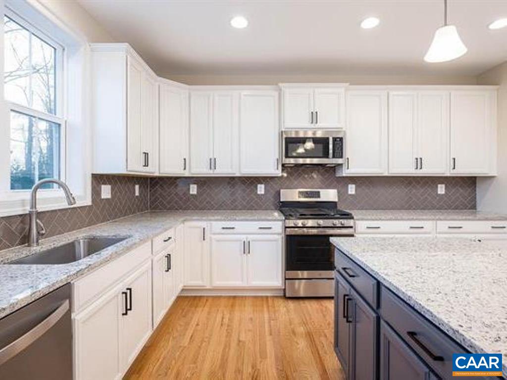 6 Ridgeview Drive Ruckersville, VA 22968 - Photo 20 of 32 a kitchen with granite countertop a stove top oven sink and cabinets