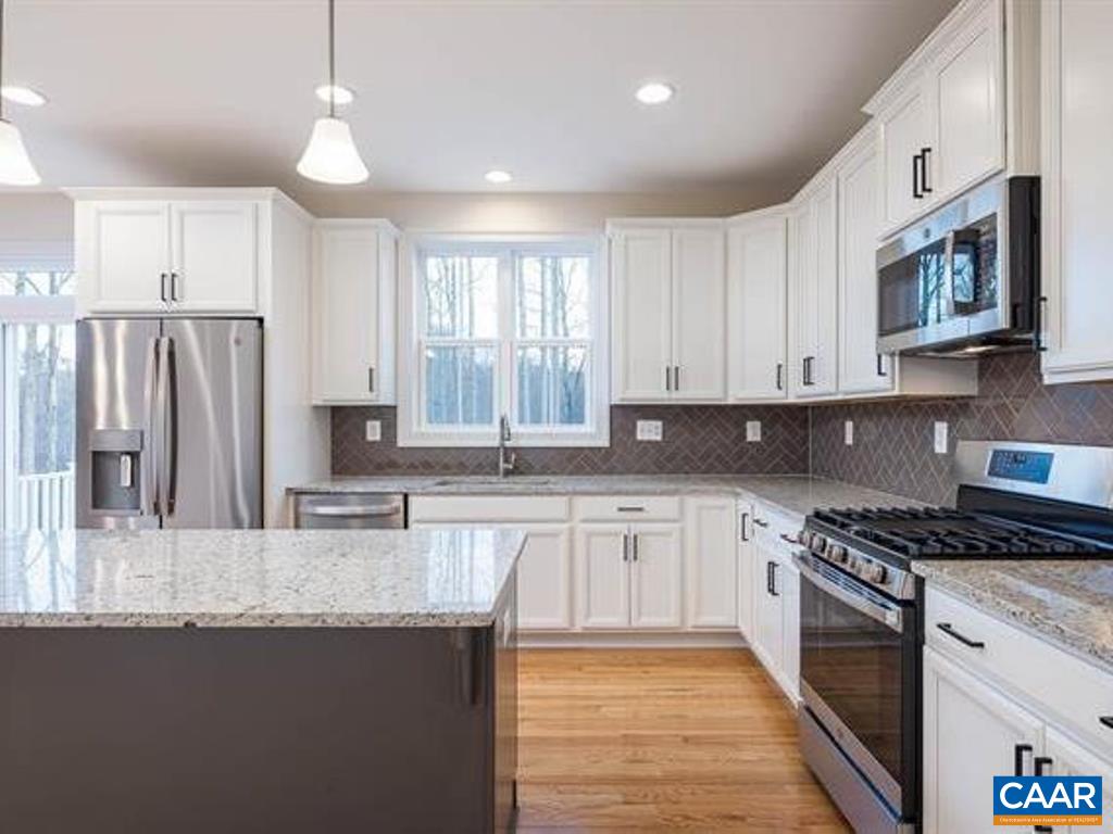 6 Ridgeview Drive Ruckersville, VA 22968 - Photo 21 of 32 a kitchen with stainless steel appliances granite countertop a stove a sink and a refrigerator