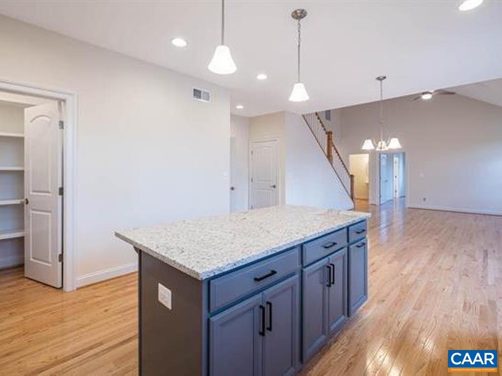 6 Ridgeview Drive Ruckersville, VA 22968 - Photo 22 of 32 a kitchen with a wooden floor and a refrigerator