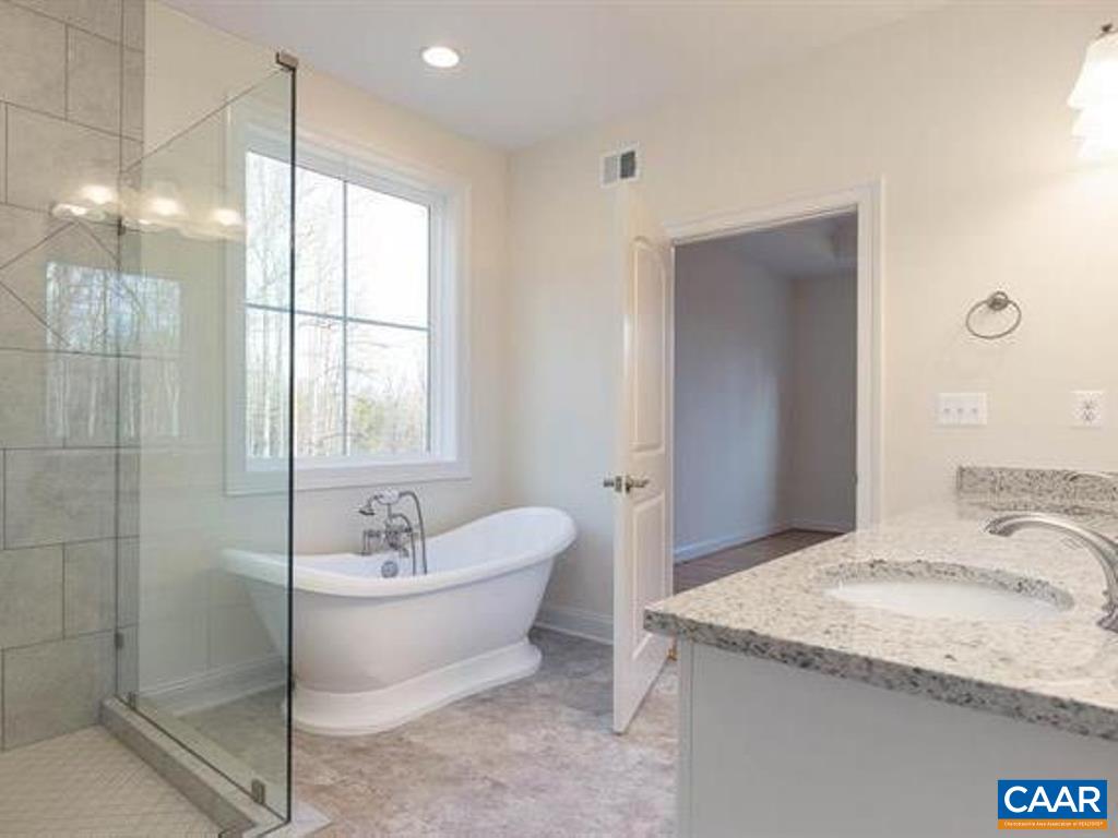 6 Ridgeview Drive Ruckersville, VA 22968 - Photo 28 of 32 a spacious bathroom with a granite countertop sink and a mirror