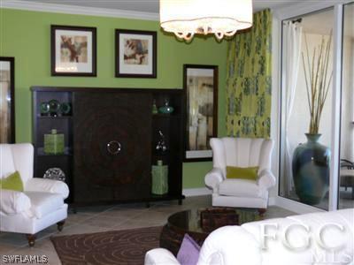 2090 West First Street, Unit 2007 Fort Myers, FL 33901 - Photo 2 of 10 a living room with furniture and a chandelier