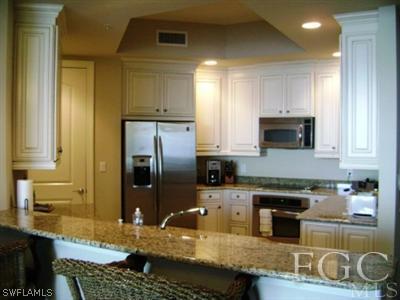 2090 West First Street, Unit 2007 Fort Myers, FL 33901 - Photo 3 of 10 a kitchen with granite countertop a sink a stove and refrigerator