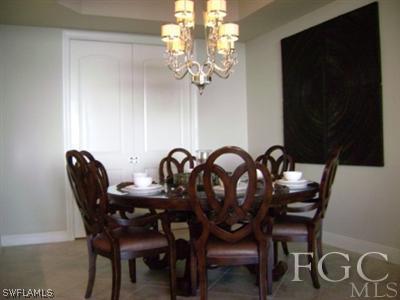 2090 West First Street, Unit 2007 Fort Myers, FL 33901 - Photo 5 of 10 a view of a dining room with furniture and chandelier