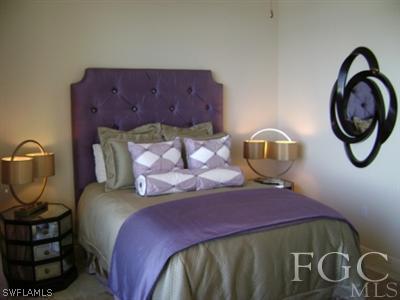 2090 West First Street, Unit 2007 Fort Myers, FL 33901 - Photo 6 of 10 a bed sitting in a bedroom next to a window