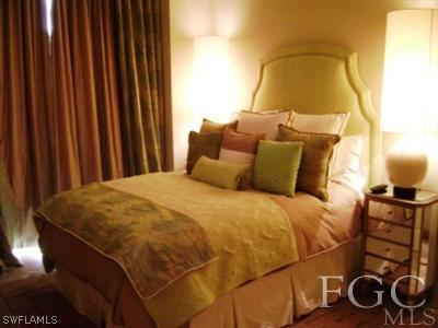 2090 West First Street, Unit 2007 Fort Myers, FL 33901 - Photo 9 of 10 a bedroom with a bed and a painting on the wall