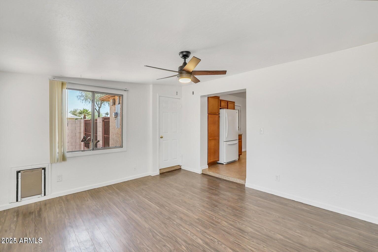 1526 West Huntington Drive Tempe, AZ 85282 - Photo 12 of 17 a view of an empty room with window and wooden floor
