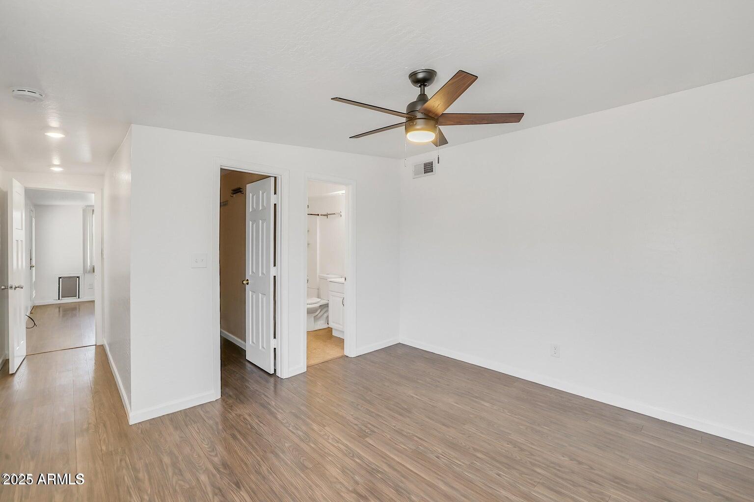 1526 West Huntington Drive Tempe, AZ 85282 - Photo 13 of 17 a view of a livingroom with wooden floor and a ceiling fan