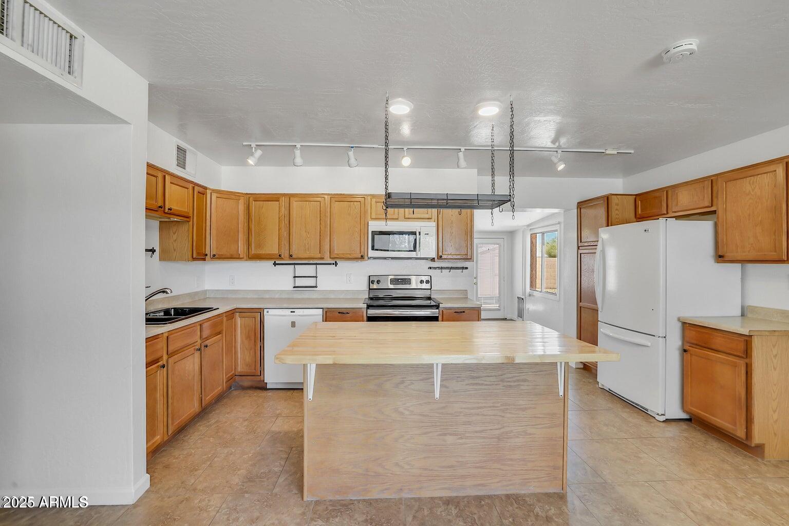 1526 West Huntington Drive Tempe, AZ 85282 - Photo 4 of 17 a kitchen with stainless steel appliances granite countertop a refrigerator a stove and a sink