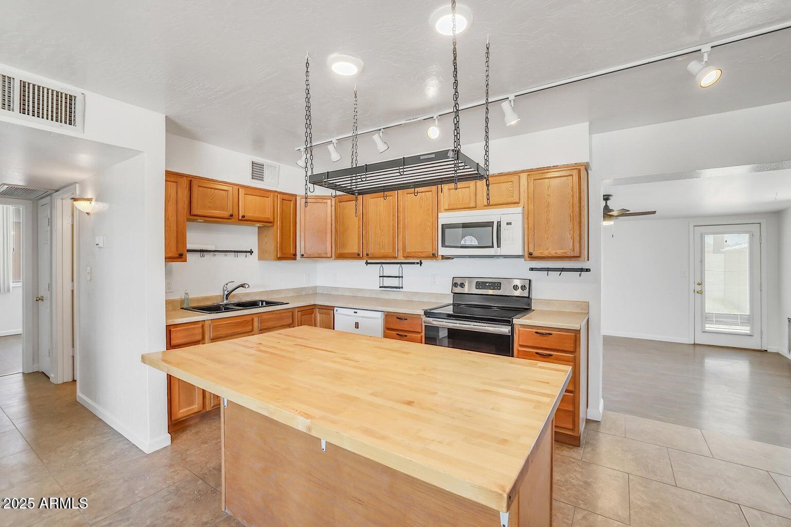 1526 West Huntington Drive Tempe, AZ 85282 - Photo 5 of 17 a kitchen with stainless steel appliances granite countertop a sink a stove and a refrigerator