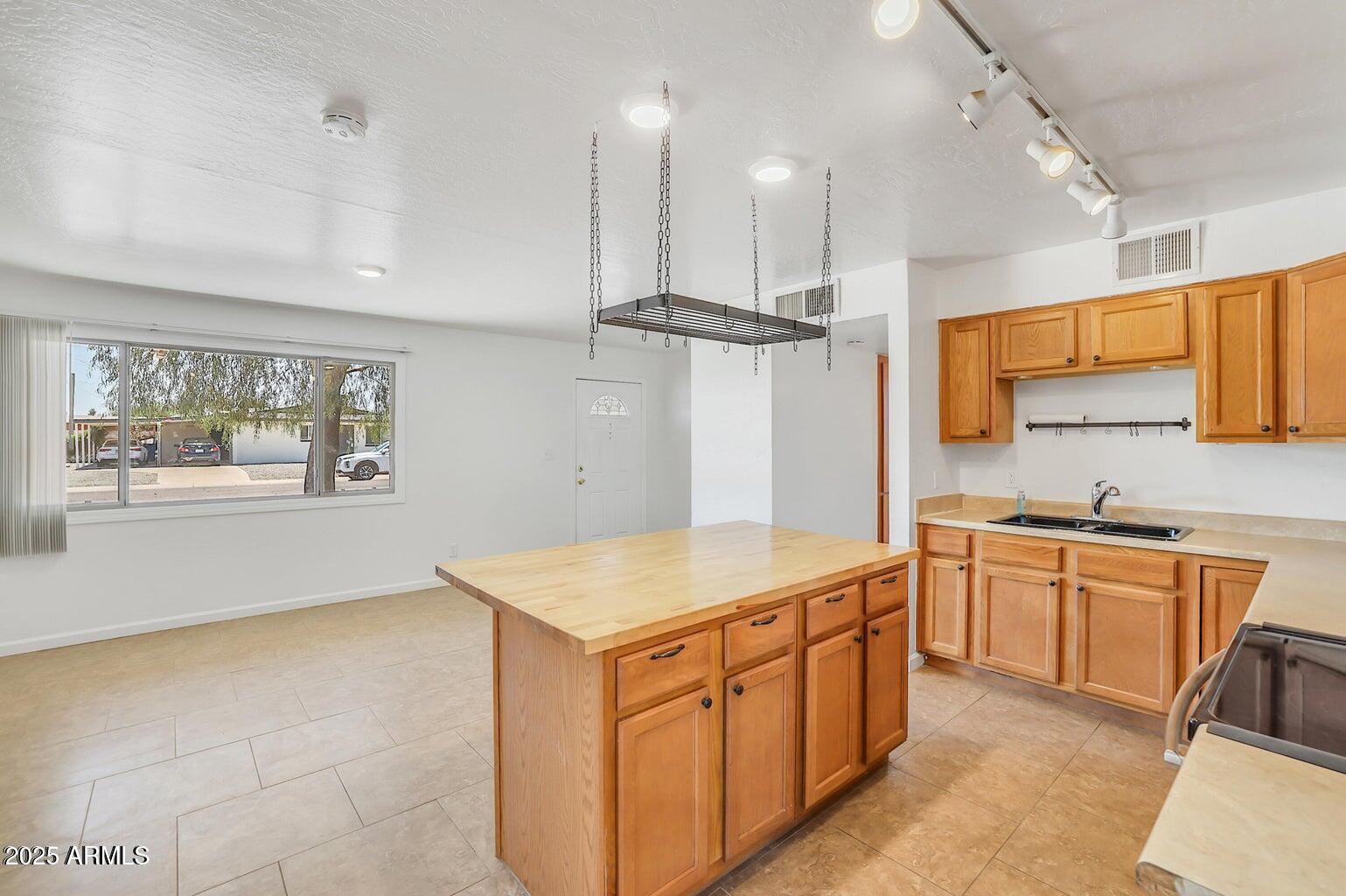 1526 West Huntington Drive Tempe, AZ 85282 - Photo 7 of 17 a kitchen with stainless steel appliances granite countertop a sink stove and refrigerator