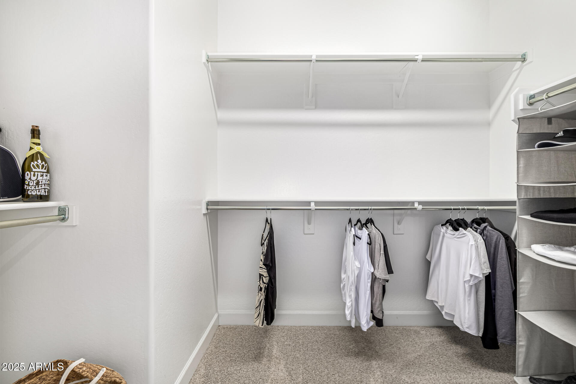 16897 West Merrell Street Goodyear, AZ 85395 - Photo 11 of 21 a view of walk in closet with clothes and shoes