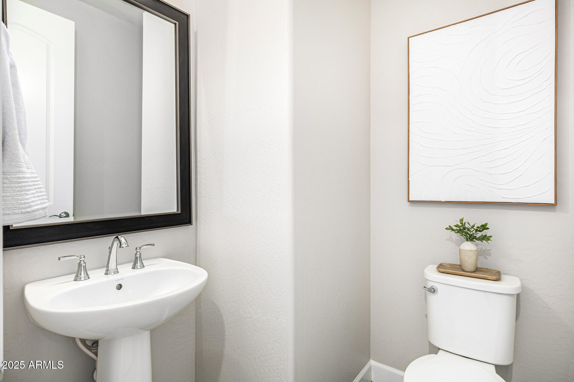 16897 West Merrell Street Goodyear, AZ 85395 - Photo 16 of 21 a bathroom with a sink a toilet and mirror