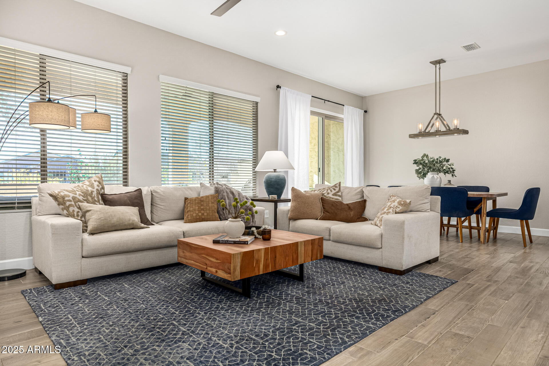 16897 West Merrell Street Goodyear, AZ 85395 - Photo 4 of 21 a living room with furniture ceiling fan and a window