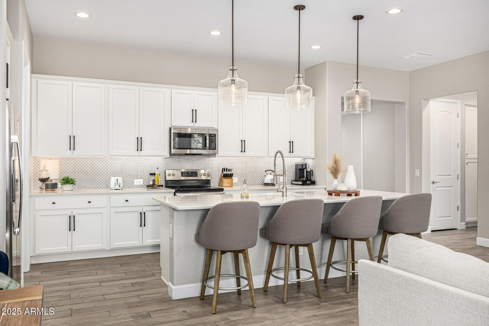 16897 West Merrell Street Goodyear, AZ 85395 - Photo 6 of 21 a kitchen with stainless steel appliances granite countertop a kitchen island a stove and a cabinets