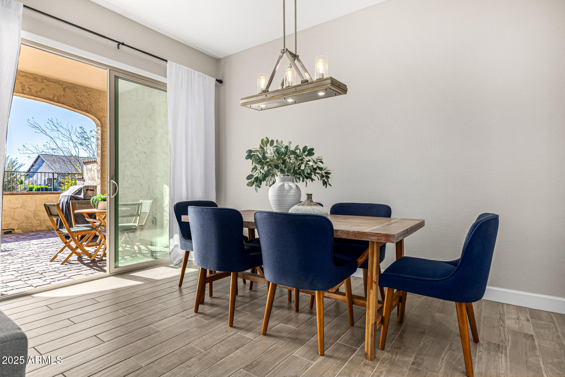 16897 West Merrell Street Goodyear, AZ 85395 - Photo 8 of 21 a view of a dining room with furniture window and wooden floor