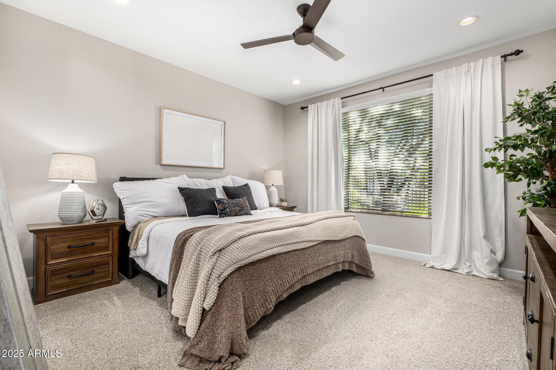 16897 West Merrell Street Goodyear, AZ 85395 - Photo 9 of 21 a spacious bedroom with a bed and a window