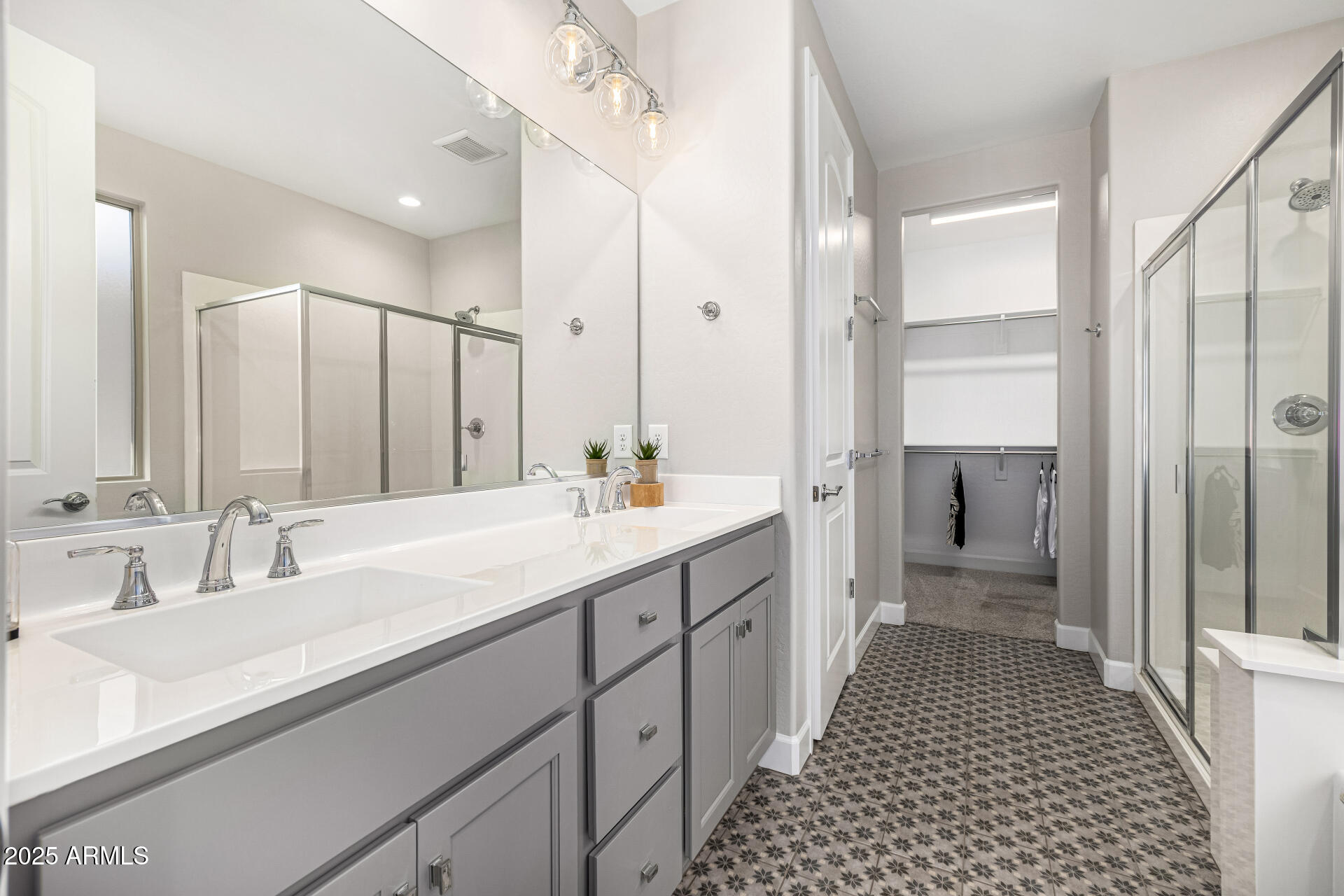 16897 West Merrell Street Goodyear, AZ 85395 - Photo 10 of 21 a bathroom with a double vanity sink and a mirror