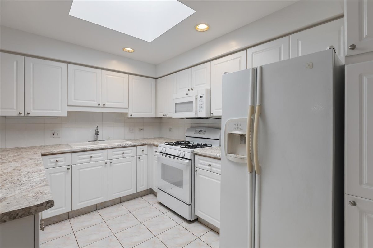 5 South Pine Street, Unit 509 Mount Prospect, IL 60056 - Photo 11 of 31 a kitchen with white cabinets and white stainless steel appliances