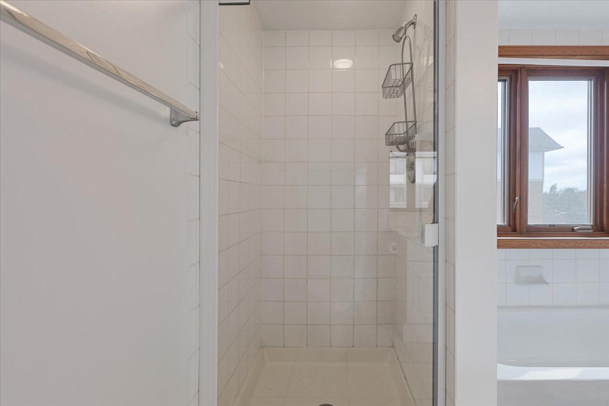 5 South Pine Street, Unit 509 Mount Prospect, IL 60056 - Photo 19 of 31 a bathroom with a glass shower door