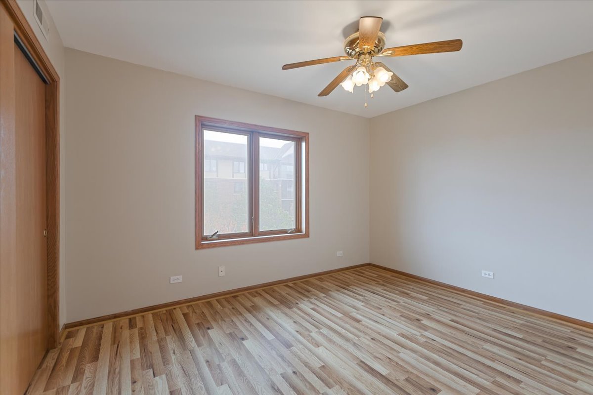 5 South Pine Street, Unit 509 Mount Prospect, IL 60056 - Photo 23 of 31 a view of an empty room with window and wooden floor