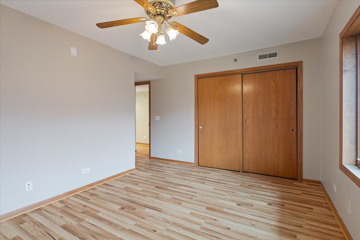 5 South Pine Street, Unit 509 Mount Prospect, IL 60056 - Photo 24 of 31 wooden floor in an empty room with a window