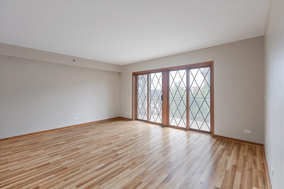 5 South Pine Street, Unit 509 Mount Prospect, IL 60056 - Photo 4 of 31 a view of an empty room with wooden floor and a window