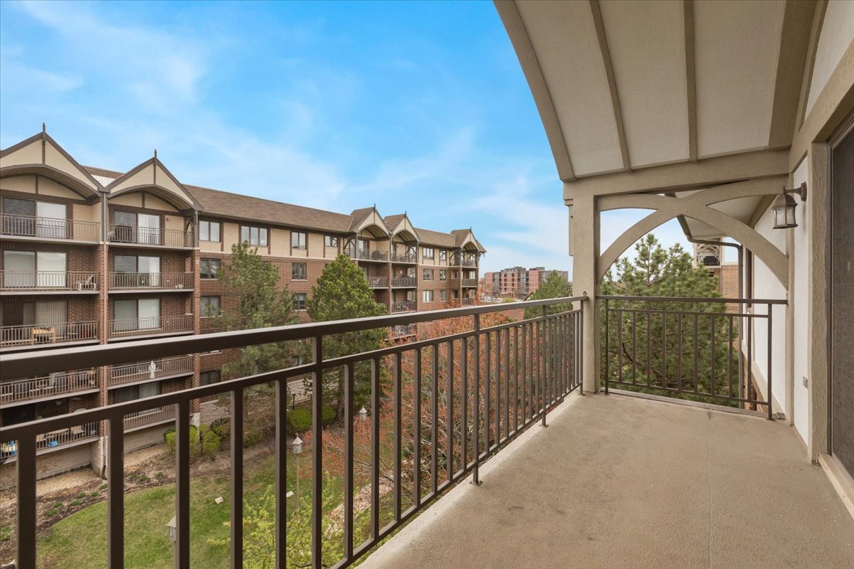 5 South Pine Street, Unit 509 Mount Prospect, IL 60056 - Photo 5 of 31 a view of a balcony with wooden floor and fence