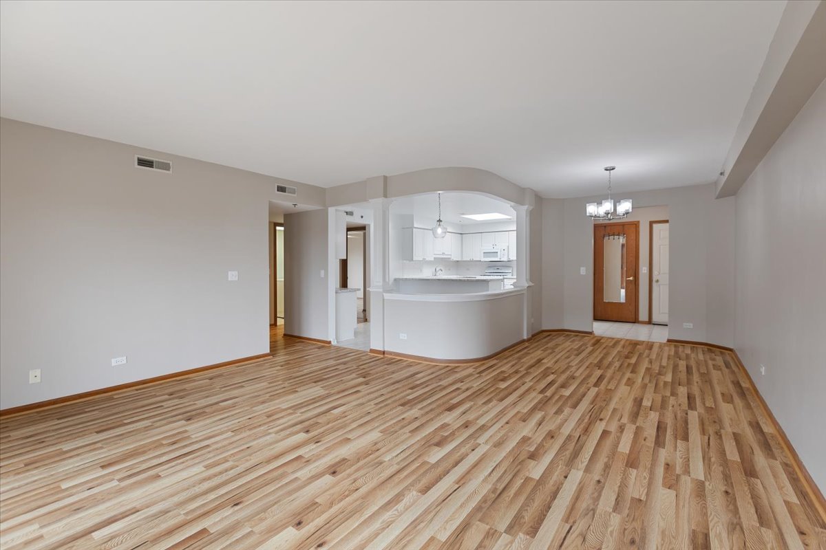 5 South Pine Street, Unit 509 Mount Prospect, IL 60056 - Photo 7 of 31 a view of empty room with wooden floor and window
