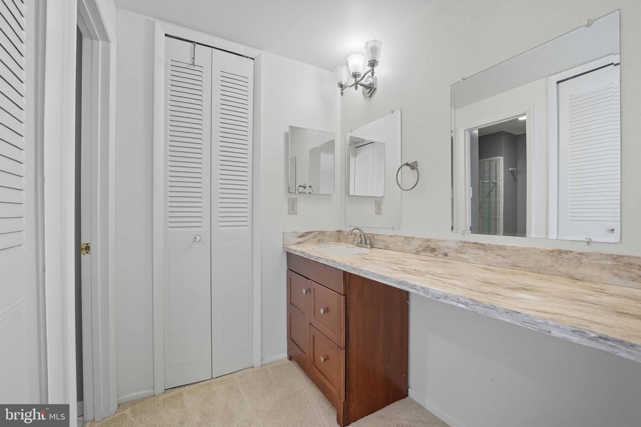 258 North Cottage Road Sterling, VA 20164 - Photo 18 of 33 a bathroom with a granite countertop sink a mirror and a vanity