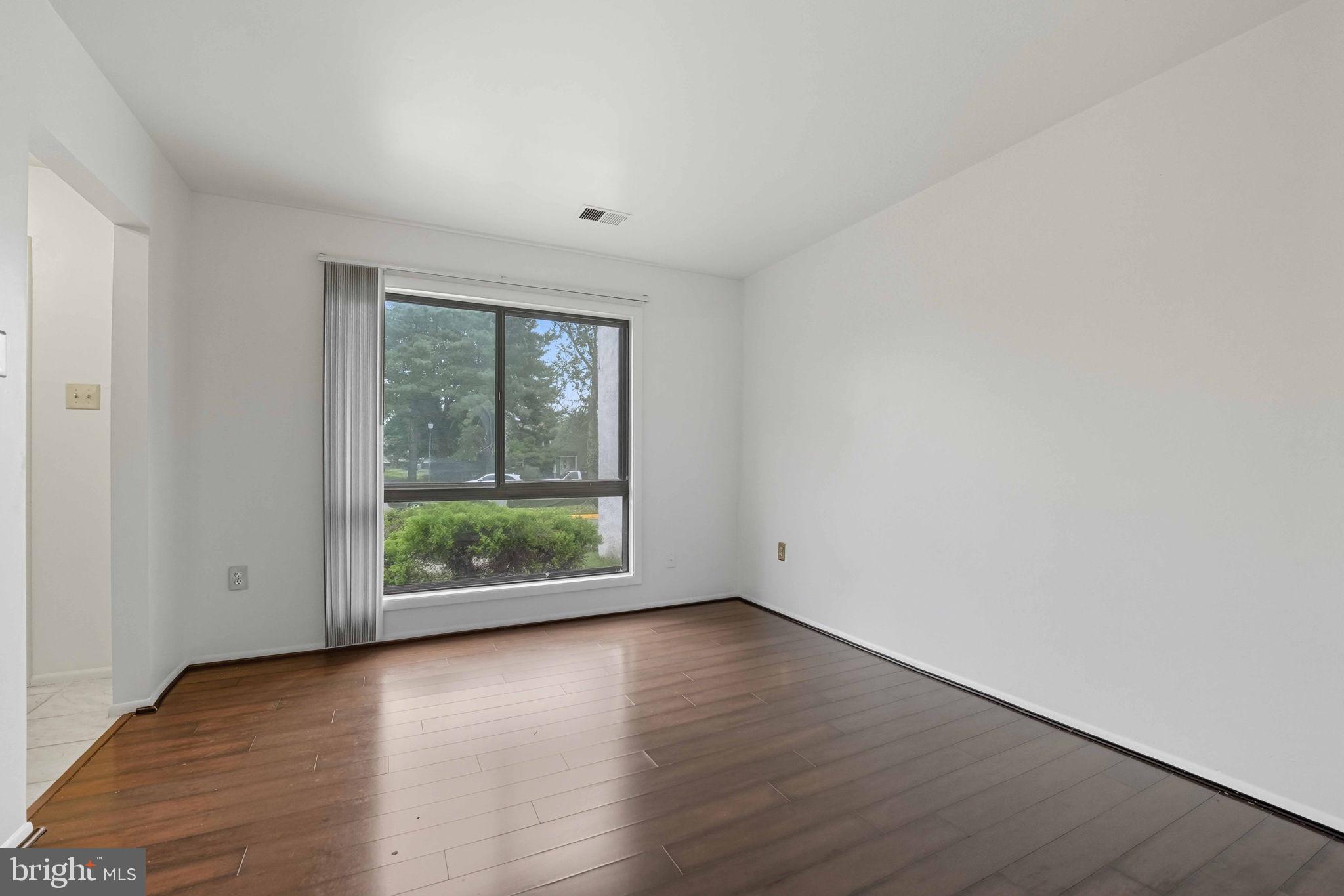 258 North Cottage Road Sterling, VA 20164 - Photo 6 of 33 an empty room with wooden floor and windows
