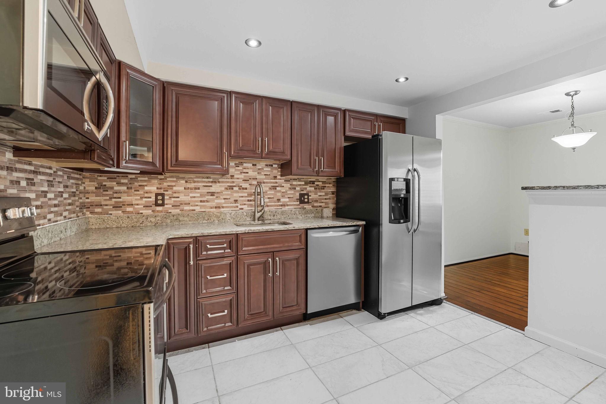 258 North Cottage Road Sterling, VA 20164 - Photo 7 of 33 a kitchen with stainless steel appliances granite countertop a refrigerator and a sink