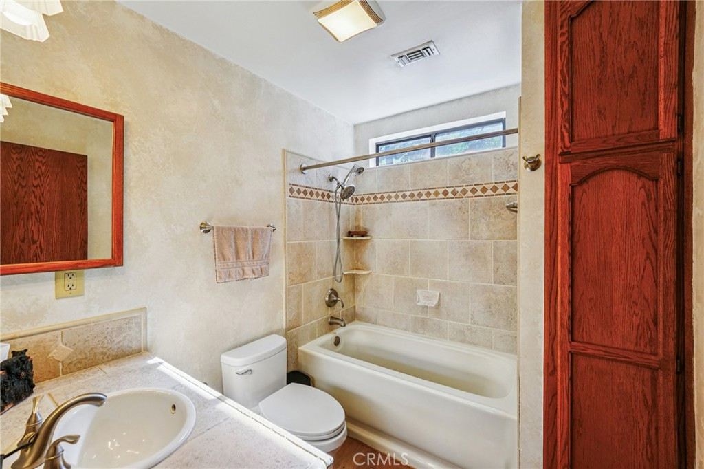 1847 Thrush Road Wrightwood, CA 92397 - Photo 12 of 33 a bathroom with a granite countertop toilet sink and bathtub