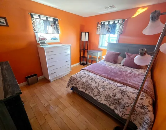 a bedroom with a bed and dresser