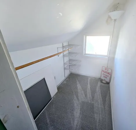 a view of storage and utility room with window