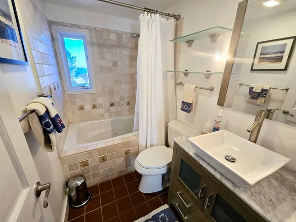 a bathroom with a sink toilet tub and shower