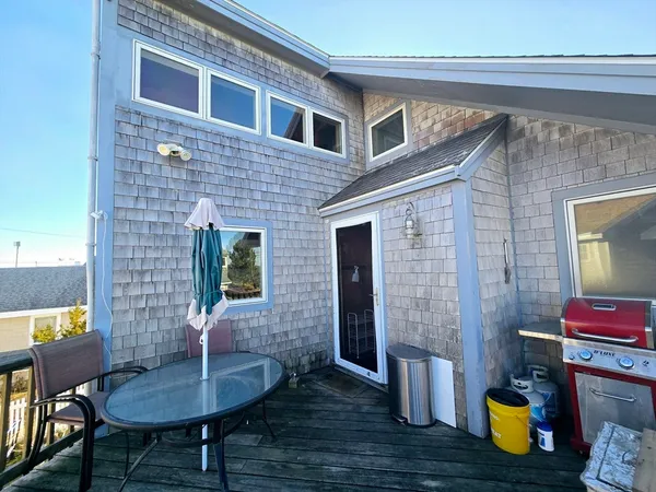 a front view of a house with outdoor seating