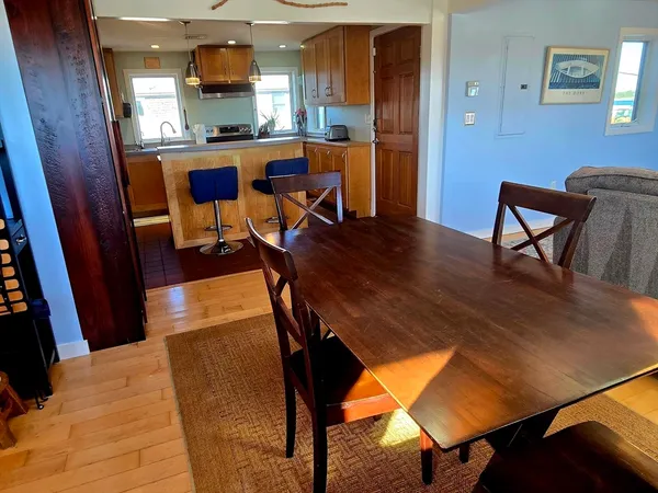 a dining room with furniture and wooden floor