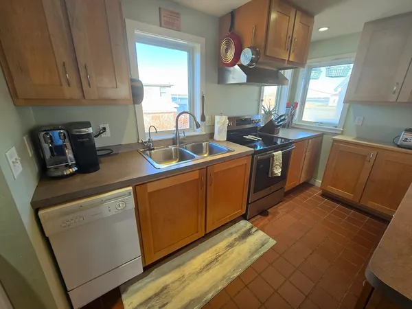 a kitchen with cabinets a sink and a stove