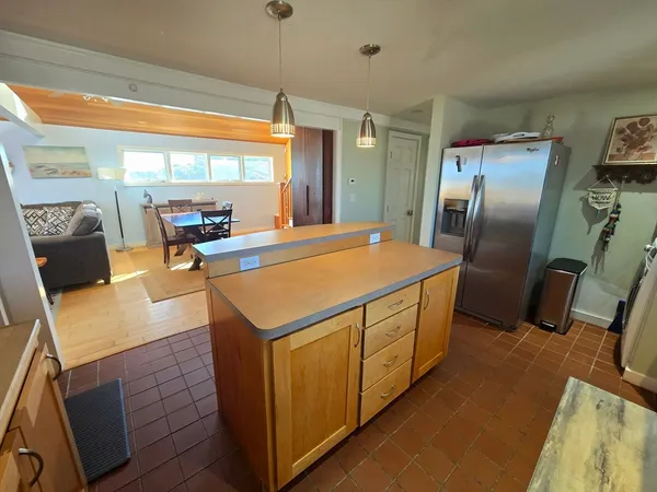 a kitchen with stainless steel appliances granite countertop a sink and a refrigerator